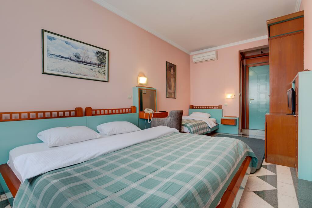 There is one Queen-Size Bed in the room along with a Single Bed. There are night stands and lamps in the room, so our guests can feel more comfortable.