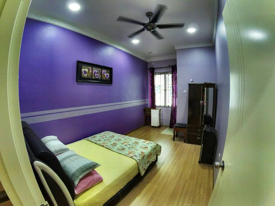 Queen size bed with attached shared bathroom