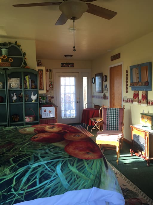 Kitchen area with table, refrigerator, microwave, coffee pot, toaster, countertop cooking plate, all dishes and silverware you will need.