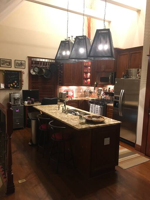 Kitchen with big island to dine at and dim-able lighting throughout.
