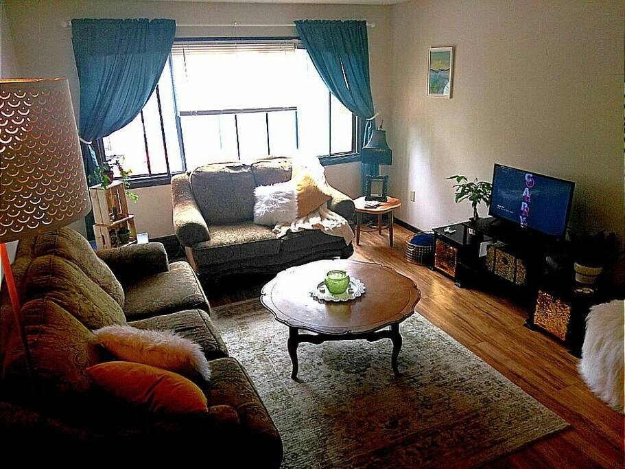 Enjoy lounging on our super comfy couch, love seat, and footstools in this spacious living room. Bright and warm mornings and days with eastern facing windows!