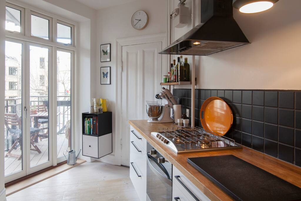 The light and welcoming kitchen and dining area. Great for cooking and socialising. Door to the balcony.