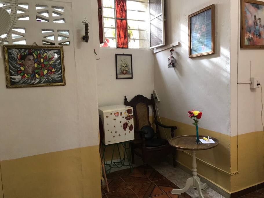 Small refrigerator and window over-looking the street.