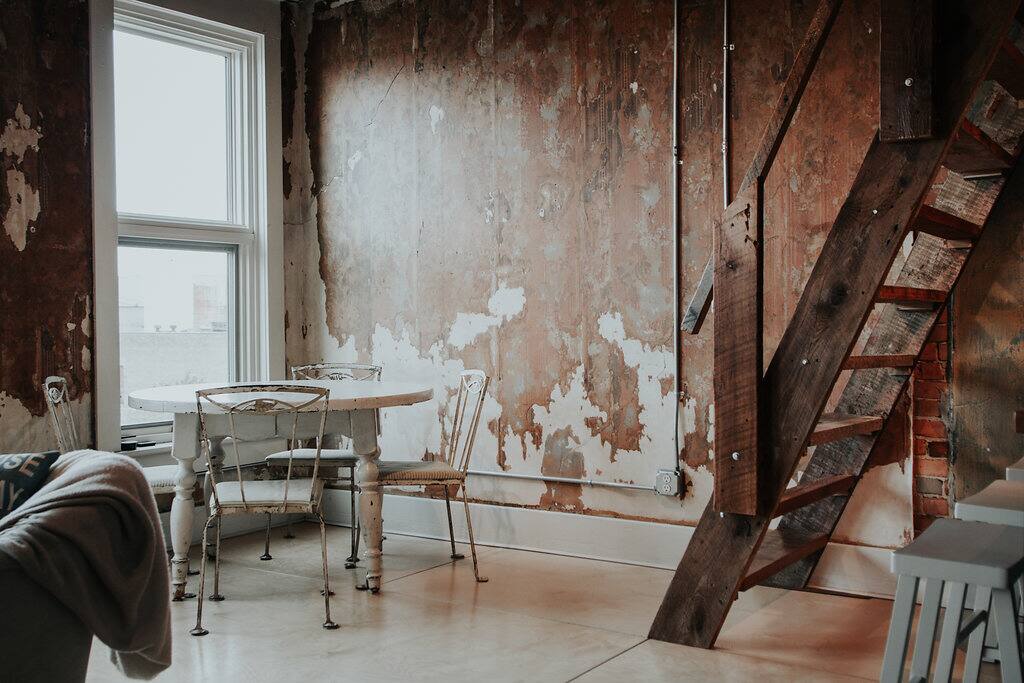 Vintage dining table, dining space, and stairway to the loft.