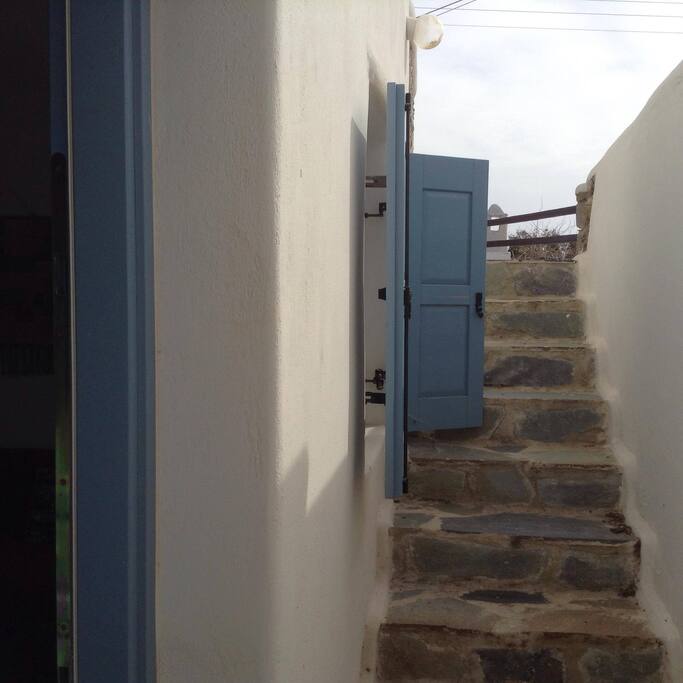 Entrance of the underground apartment. Stairs leading down to the entrance.