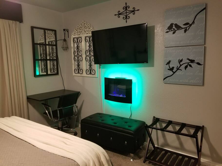 folding laptop desk area, luggage rack in the room electric fireplace heater.