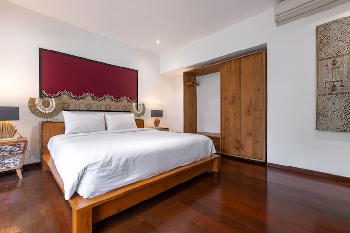 Bedroom 7 (Family Suite) - This Pool-side room features a king-size bed, and is connected to Bedroom 6, it forms a private family suite with a shared enclosed bathroom—ideal for parents staying close to children.