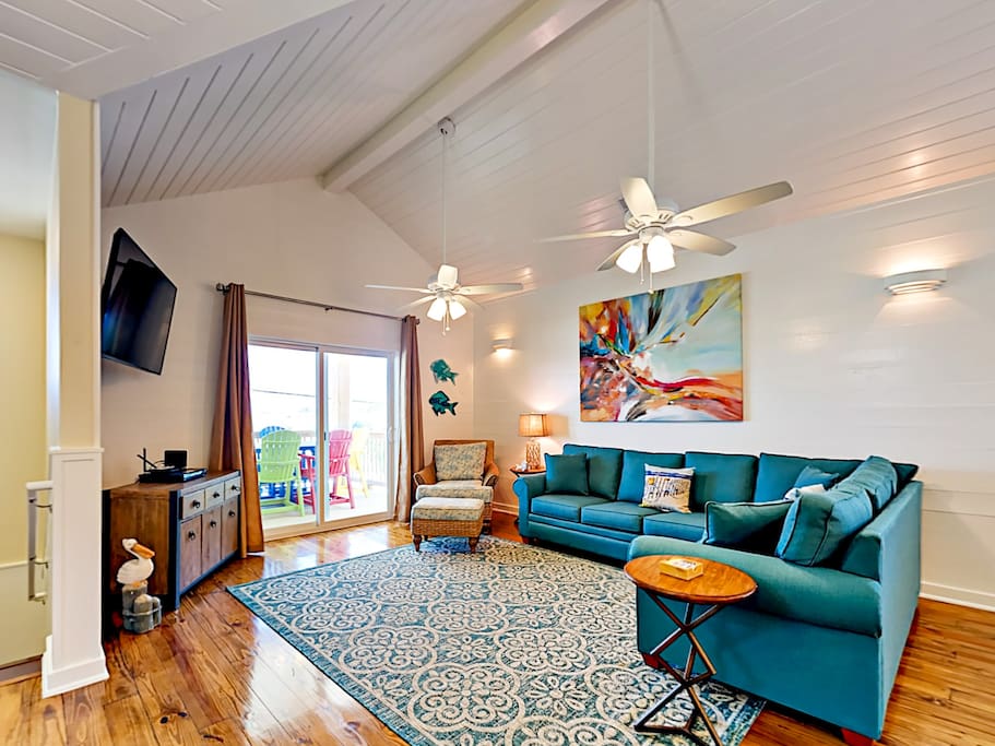 Vaulted ceilings, hardwood floors, and coastal-chic design is found throughout.
