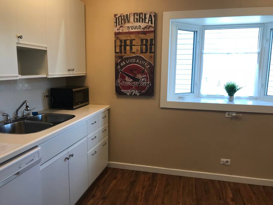 Kitchen with all the essentials including dishwasher, microwave, coffee maker, kettle, toaster, etc.