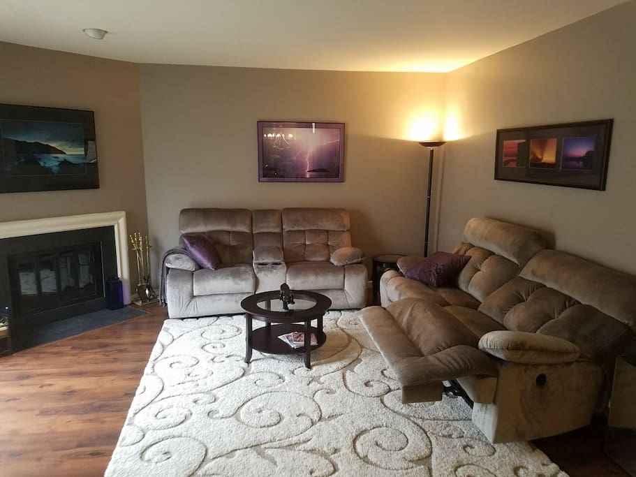 Living room with fireplace and sliders to balcony and gorgeous new laminate, new paint and new power recliners !