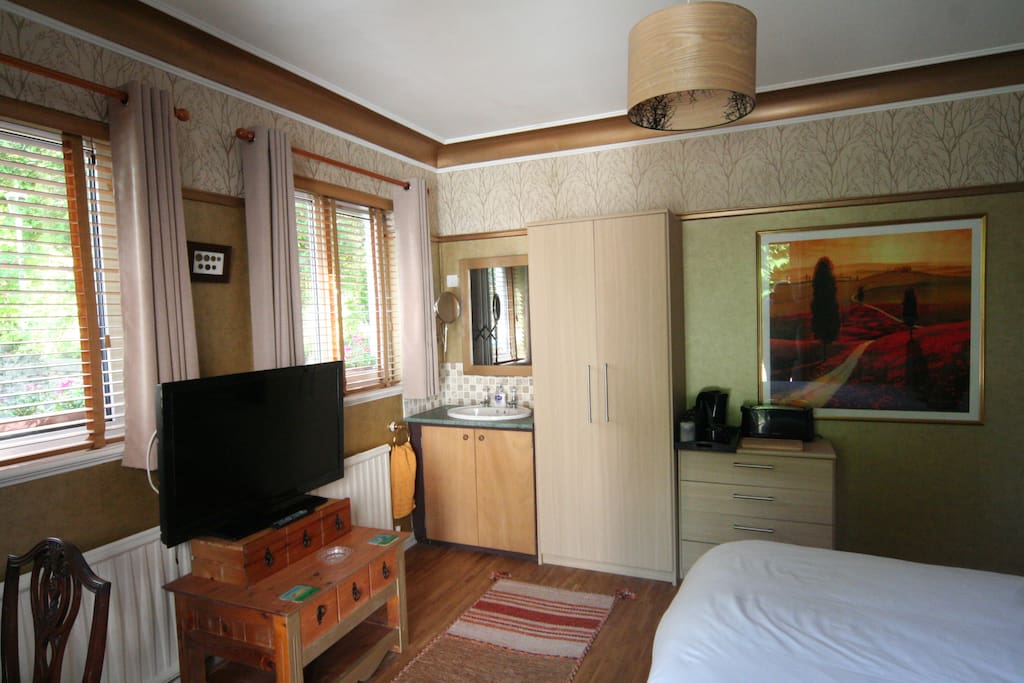 Sink, TV, and a drawer full of crockery