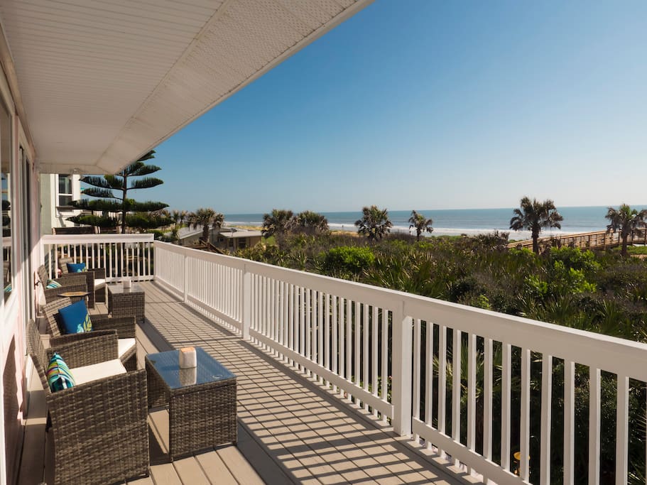 Large back porch with plenty of seating and beautiful beach views.