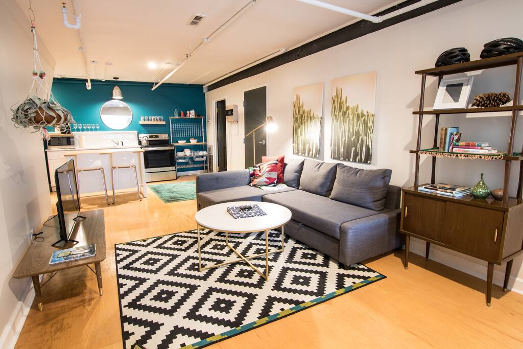 Open floor plan living/dining space. The couch folds out into a queen size bed.