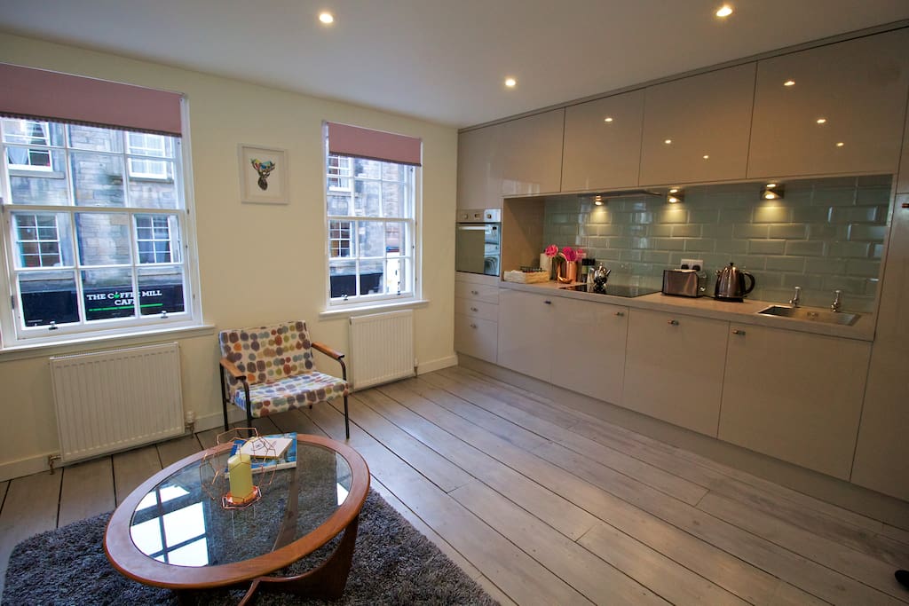 Bright, fully fitted kitchen, lounge area.