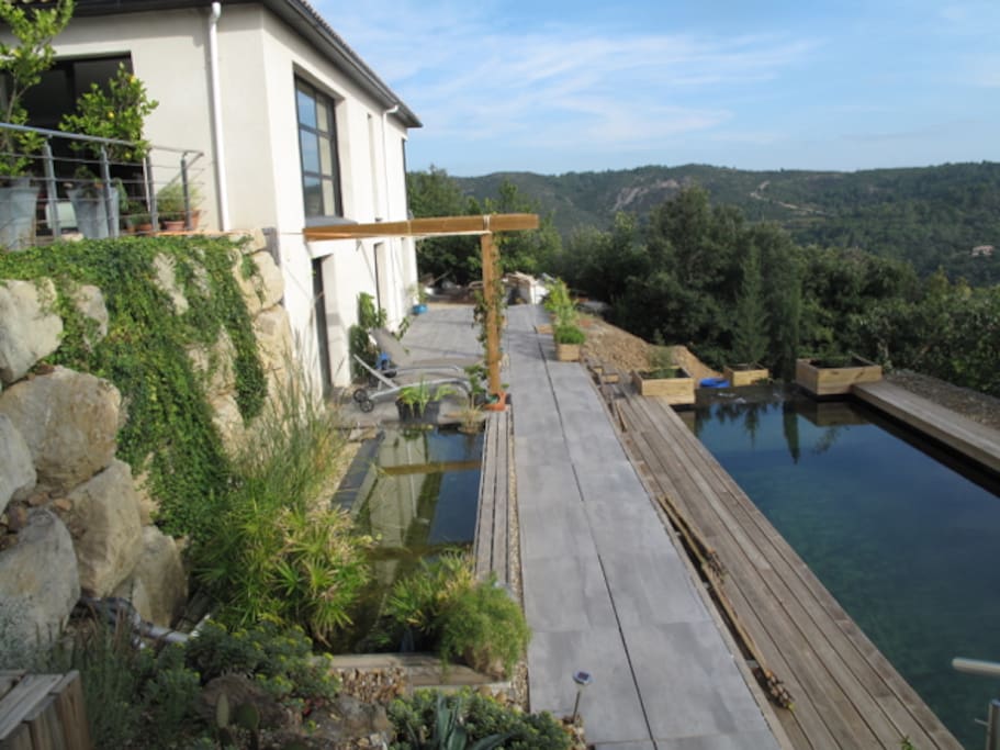 Private lower terrace covered with vines and a sail in summer