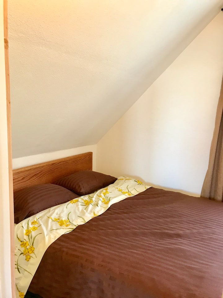 Upstairs bedroom 2. Small but has queen bed.