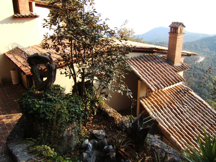 The top of the house from the dirt road that leads to the house.