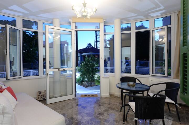 Unique Patio, "Sun Room" for dining/relaxation. May be used as a guest room with a comfortable Sofa-Bed. Evening view.