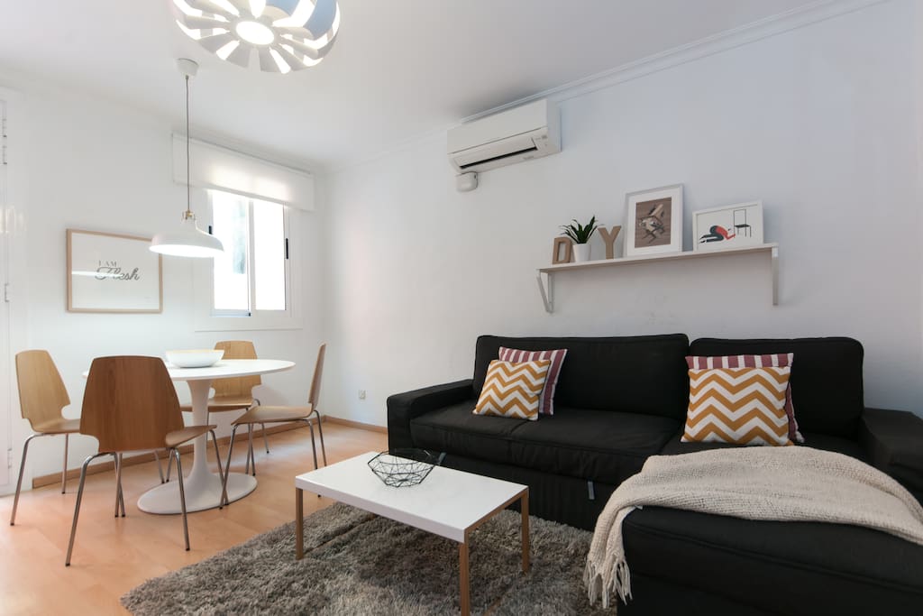 The dining table is next to the sofabed