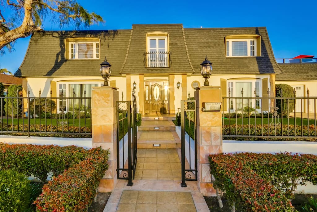 Styled like a French Manor house, ornate wrought iron fence surrounds entire front.