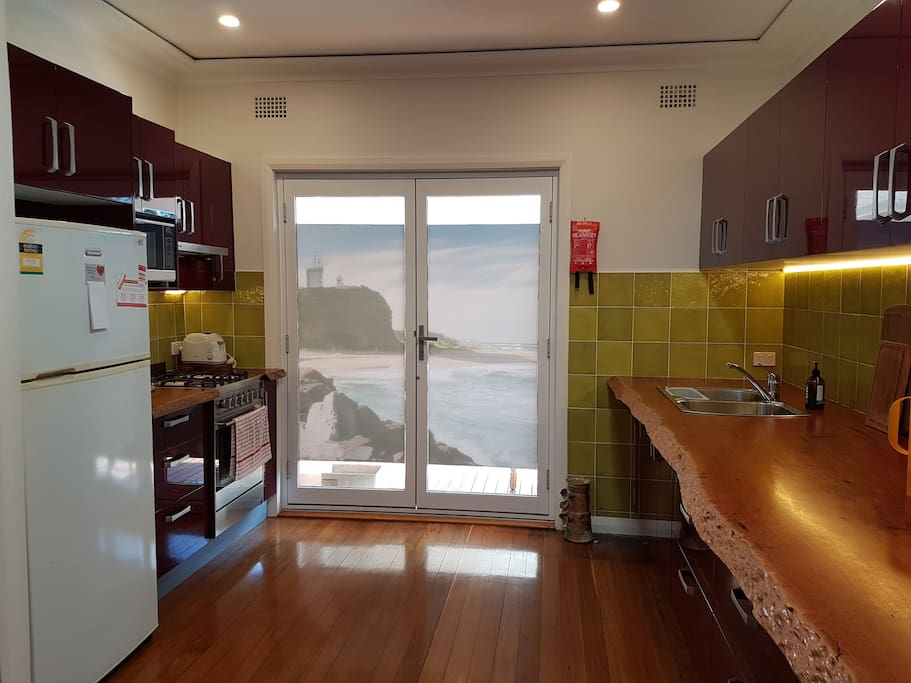 Gourmet kitchen with gas stove and oven, microwave, fridge, and beautiful benches