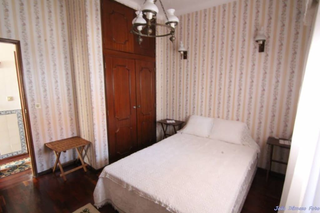 bedroom with double bed and shared bathroom