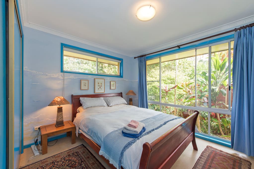 Blue bedroom with hand-painted wave mural