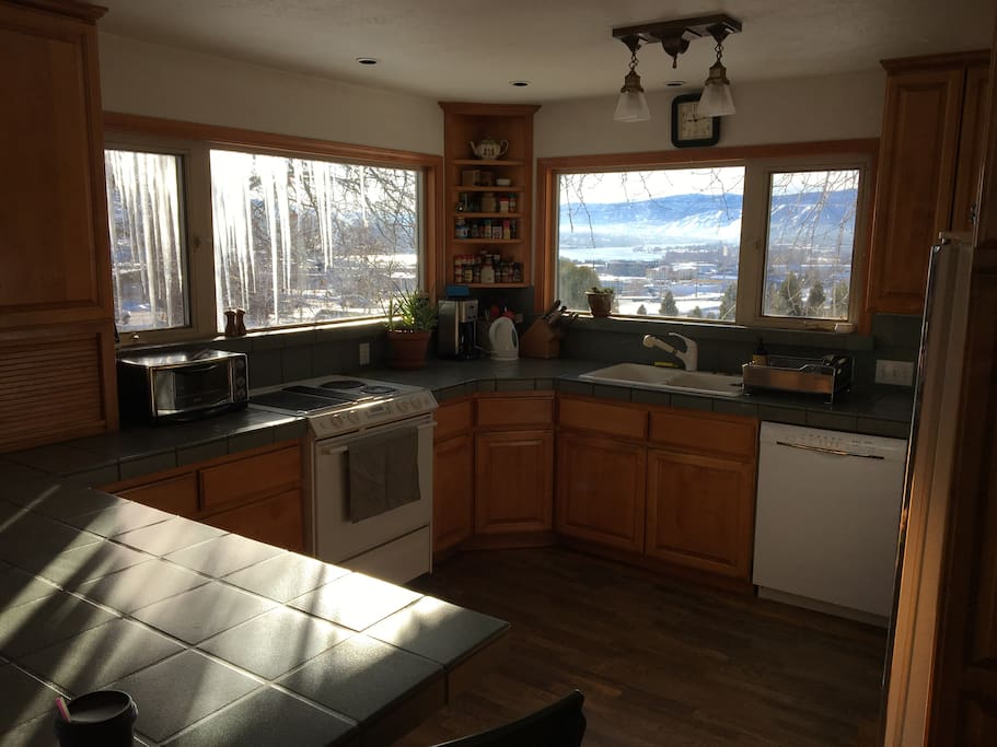 Sunny, fully stocked kitchen has espresso machine, coffee maker, dishwasher, fridge, stove/oven & large counter with 4 stools. You can see our view of the valley through the kitchen windows!