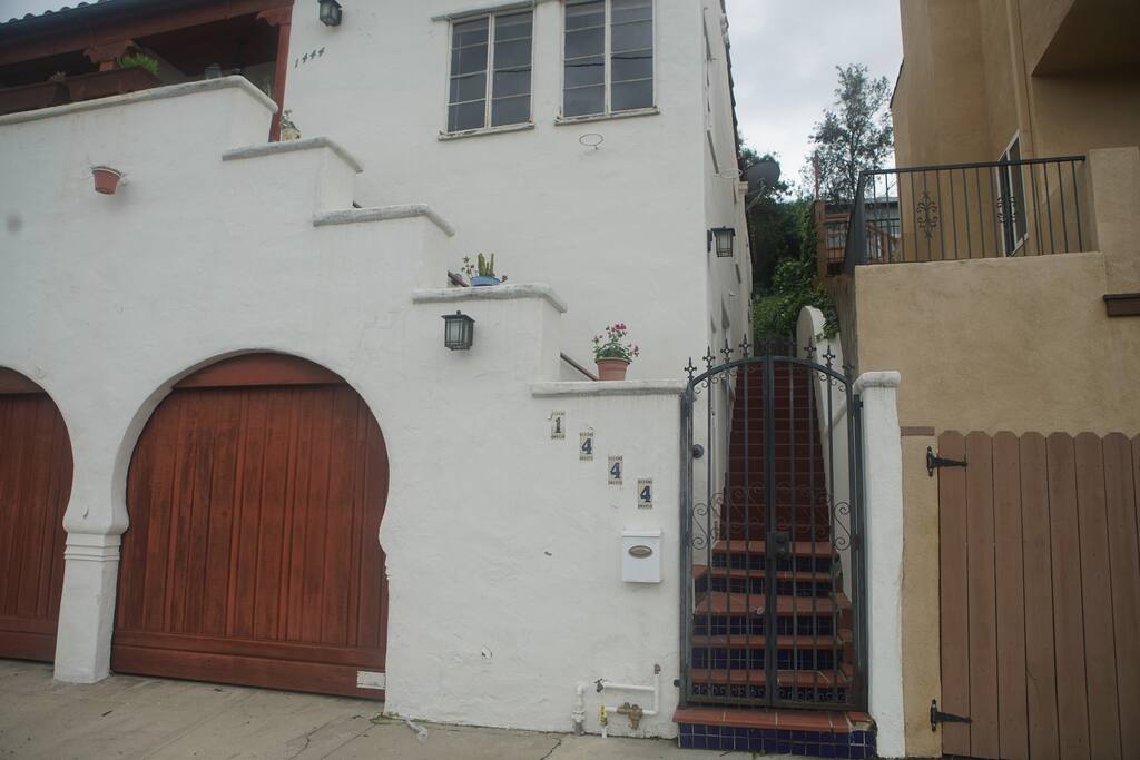 DIRECTIONS: To get to your suite, go through the black iron gate and up the red stairs to the BACK of the house. Don't go to the stairs on the Left. Once you reach the deck, go through the wood gate and your door is the first set of glass doors on the left.