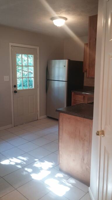 Kitchen with cooking utensils. NO dishwasher.