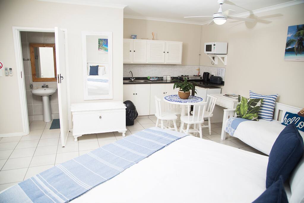 Kitchen area and en suite bathroom as seen from bed