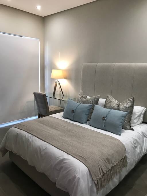 Main bedroom with Queen bed and cotton linen and towels. Open plan bedroom and bathroom.