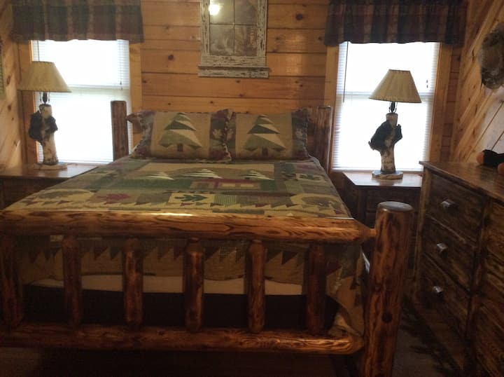 Bedroom with queen bed and rustic night stands and lamps