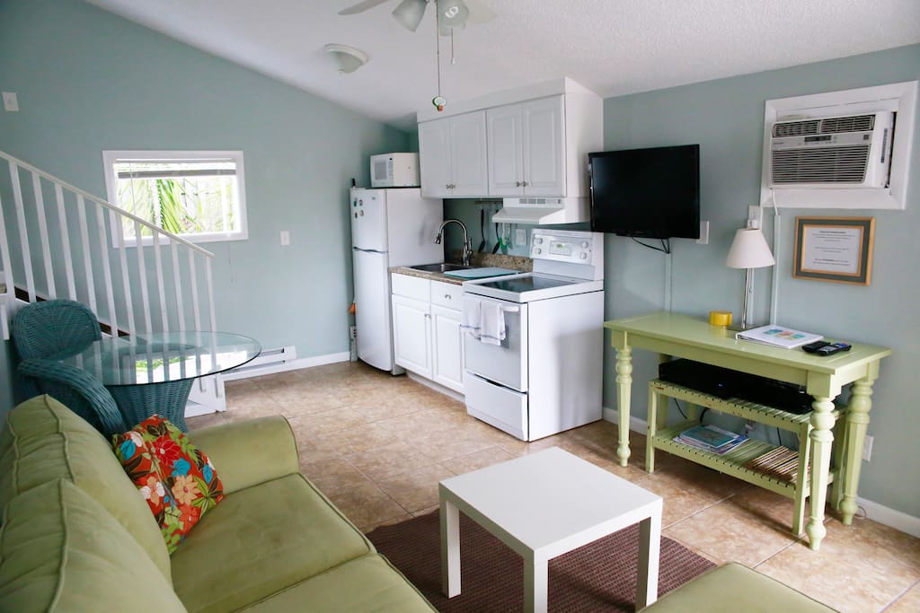 Kitchenette with stove, sink and full refrigerator