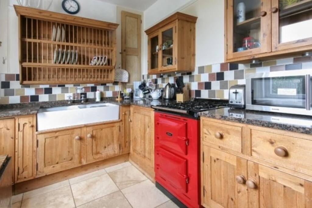 Farmhouse kitchen with Electric AGA oven and gas hob, fridge freezer, dishwasher, belfast sink