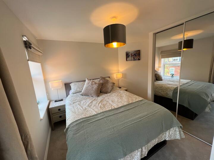 חדר שינה ראשי זוגי, עם מלתחה עם מראה, שולחנות צד, טלוויזיה ושולחנות צד 