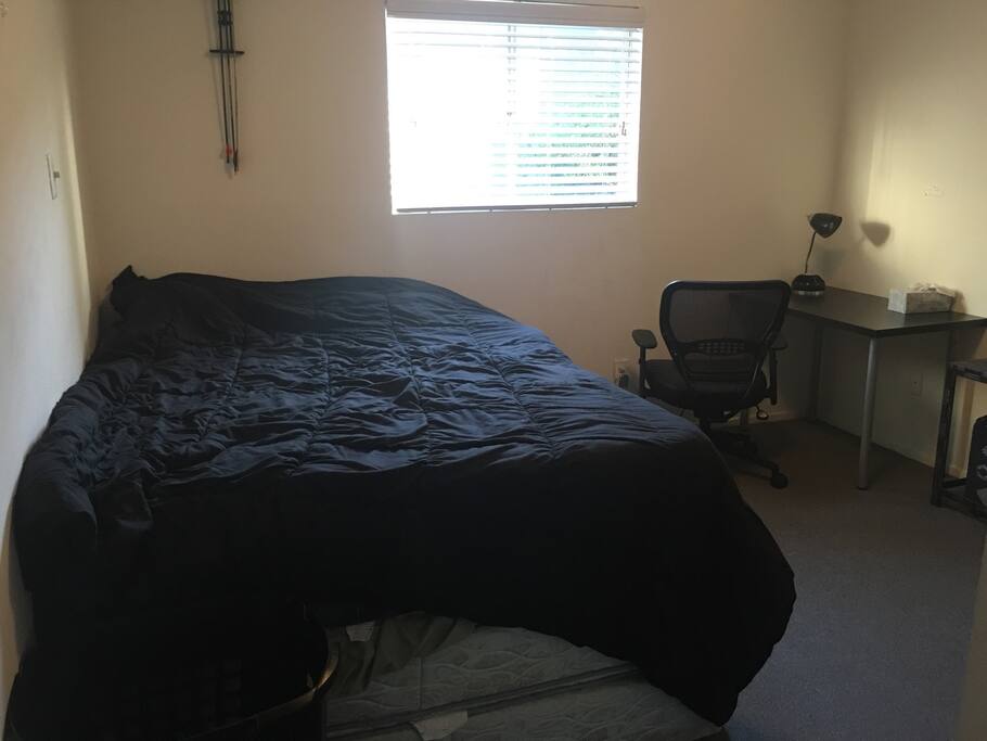 Room has a super comfortable bed as well as a desk and chair.