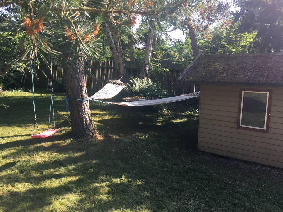 Swing and hammocks in the back end of the garden