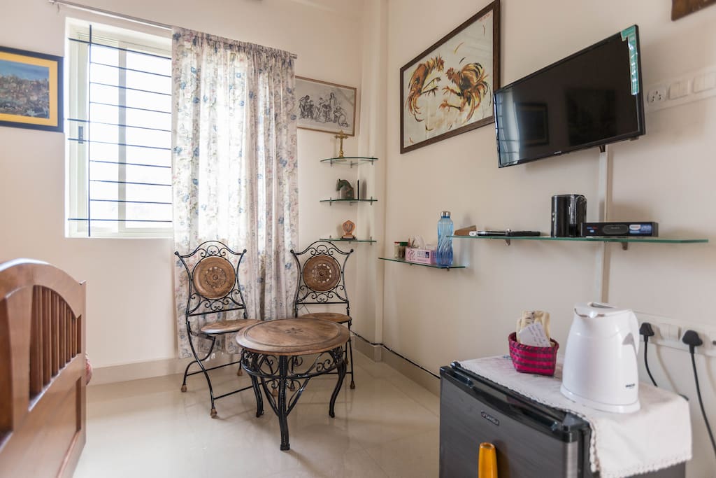 ...Enterance area showing some amenities like Mini Fridge, TV, Wi Fi & colourful Paintings