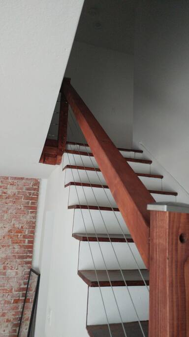 This beautifuly hand crafted stair case leads you to three bedrooms and the upper full bath.
