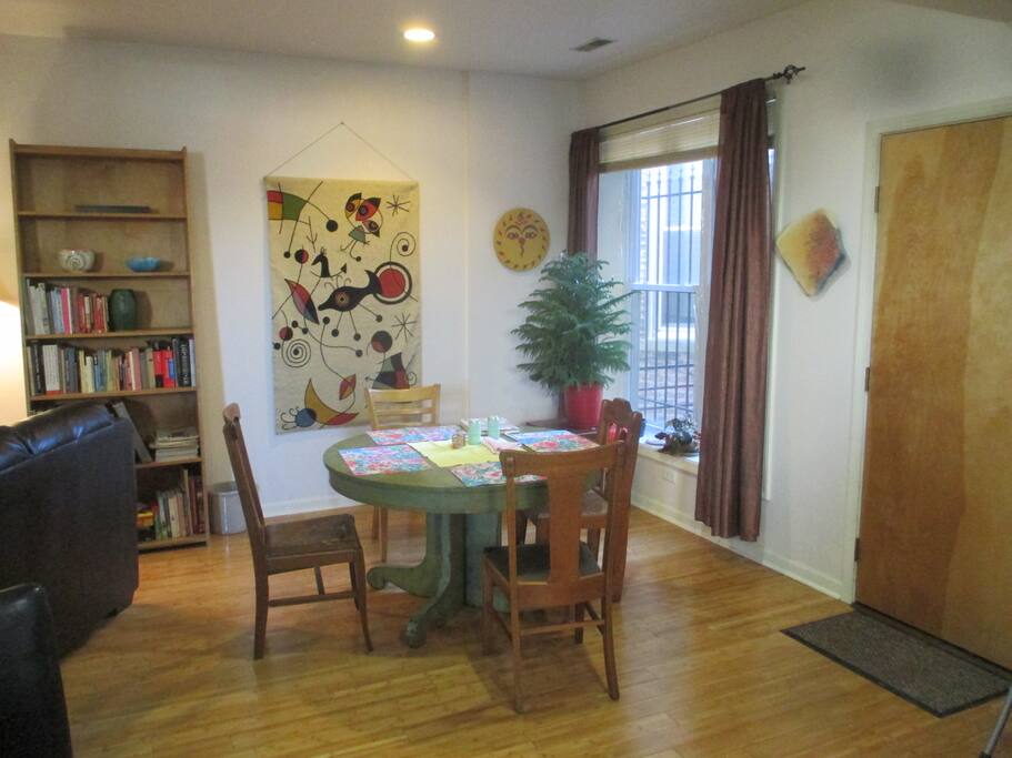 Dining area with vintage tapestry and antique table