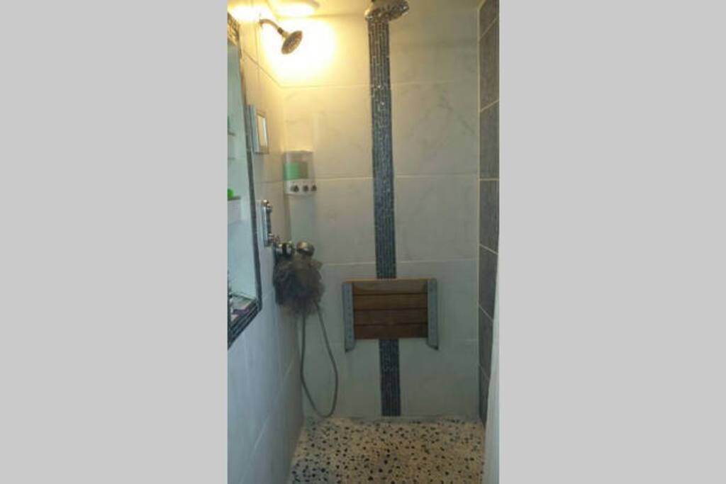 digital temperature and flow control. A diverter controls the rain downpour, shower head, and handheld, allowing any 1 or 2 to be turned on. Fold down seat.