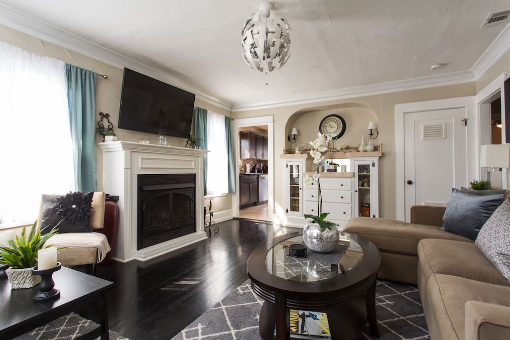 Living Room - with remote controlled fireplace w/ thermostat and stackable washer/dryer behind vented door. Iron and table can also be found in the laundry closet.
