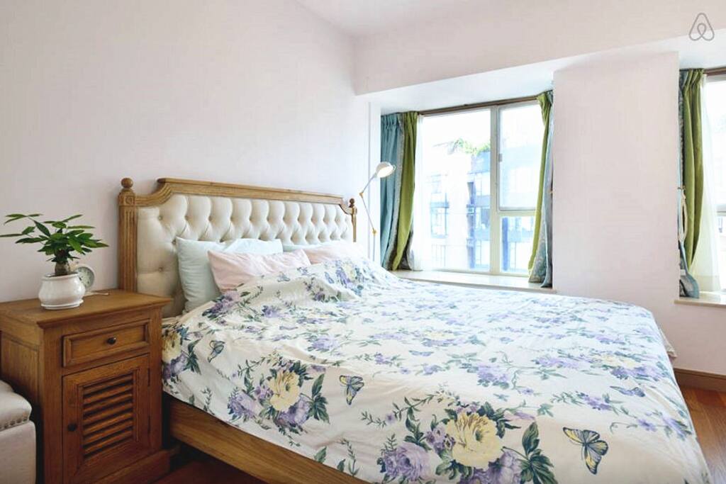 incredible spacious bedroom with three windows.