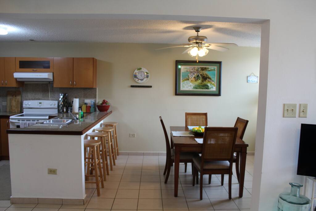 Dining area including counter top stools and dining table