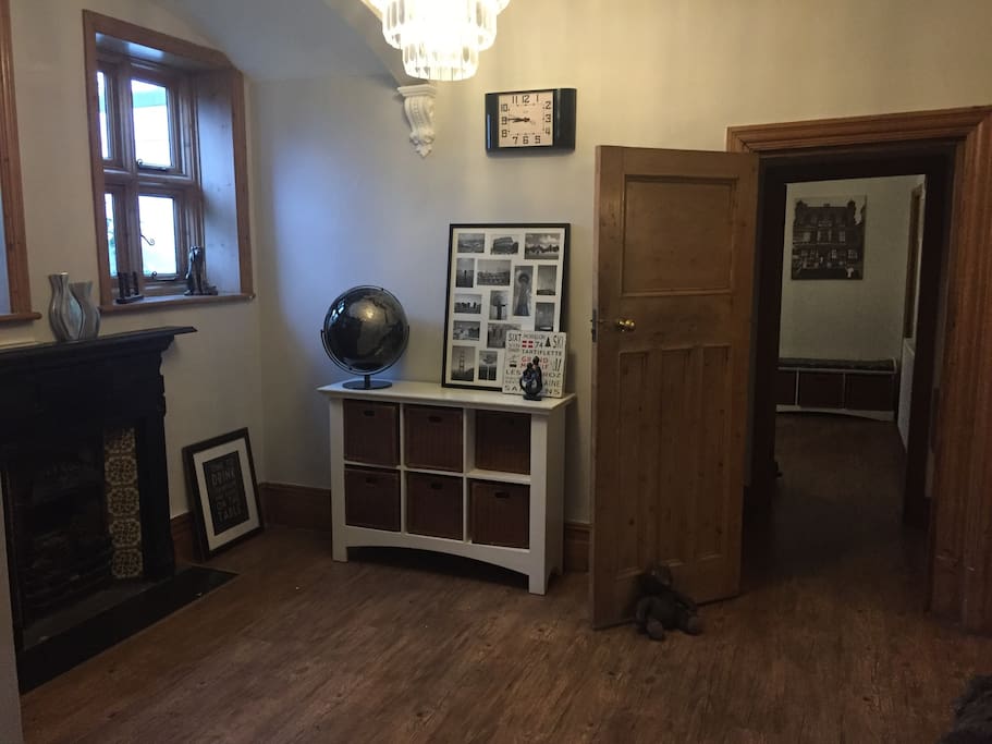 Stunning entrance hall with chandelier and fire place