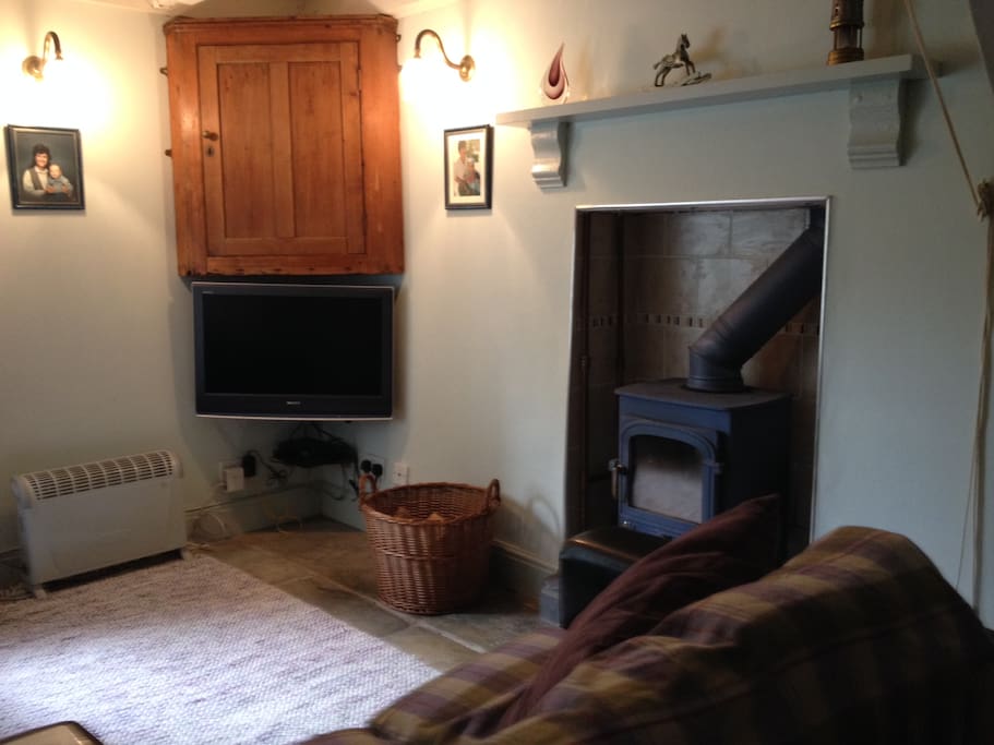 Cosy sitting room with TV and log burning stove