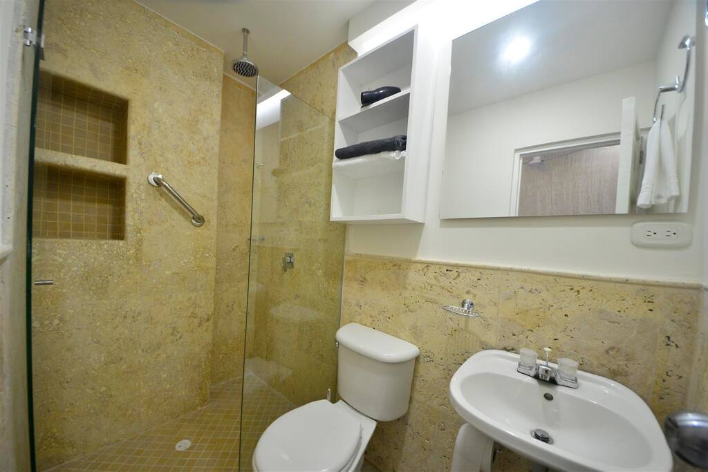 Travertine and glass bathroom
