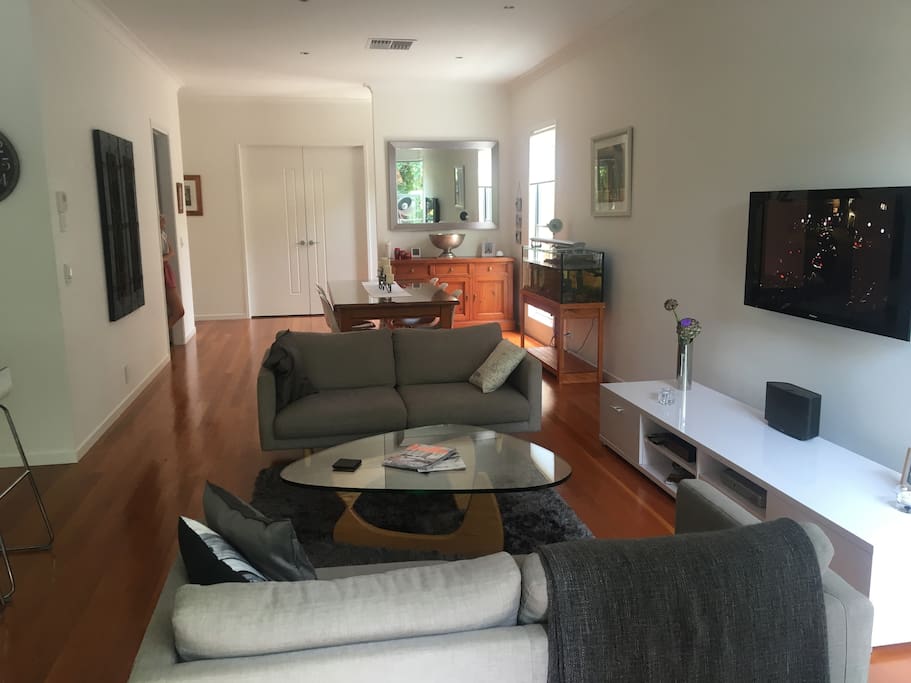 Large open plan living connected to outdoor deck and pool area