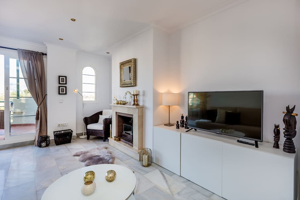 Ample and well appointed living room with fireplace apartment with sea views for rent by Puerto banus with pool
